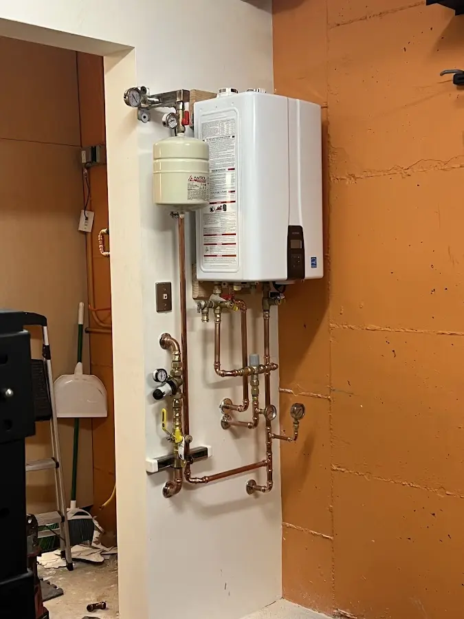 Plumbing technician inspecting water heater connections in Yucca Valley